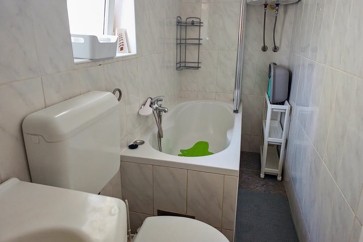 Bathroom with bathtub and marbled tile