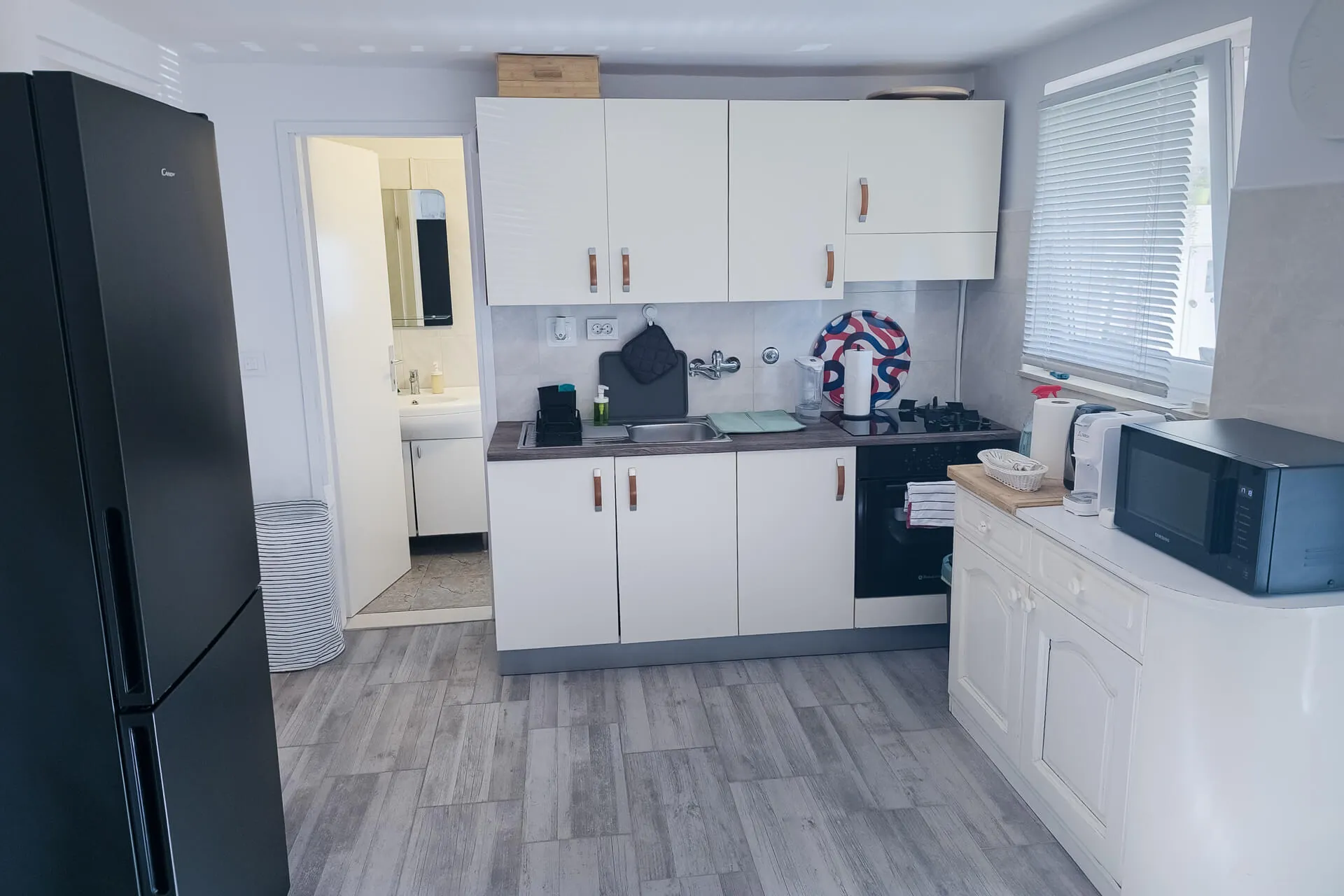 Kitchen detail: cabinets, gas cooktop, microwave